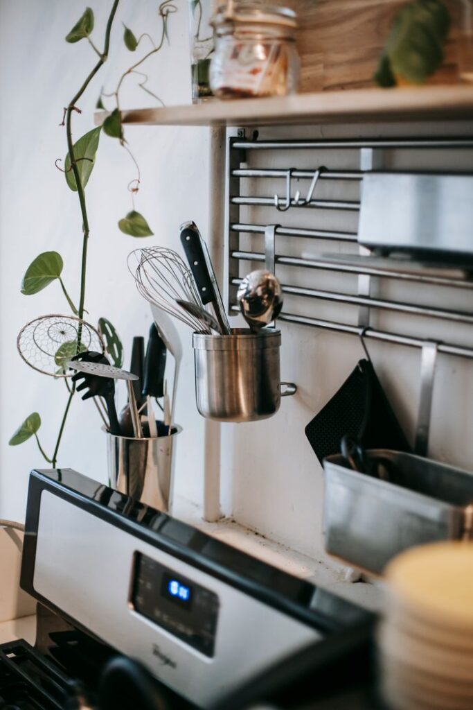Crafting Captivating Headlines: Your awesome post title goes here Kitchenware on metal rack with hooks above electric oven with display in house kitchen